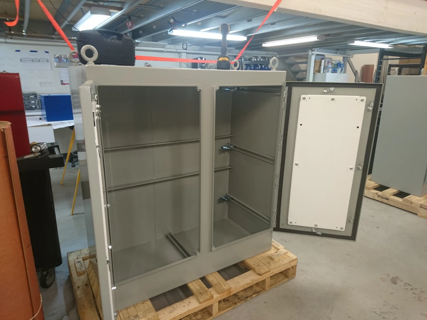 Empty painted metal cabinet with its doors open